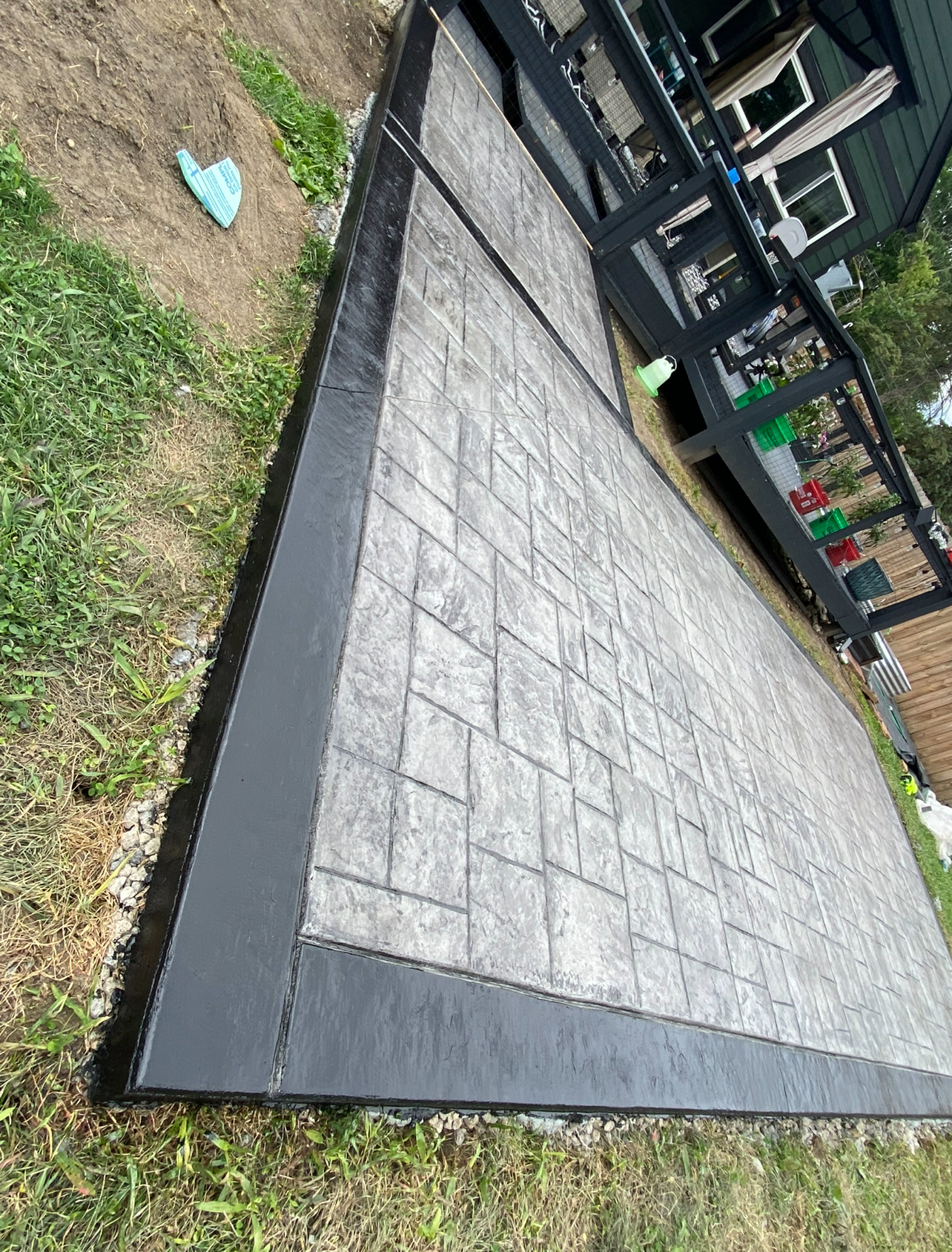Stamped concrete patio with dark charcoal border