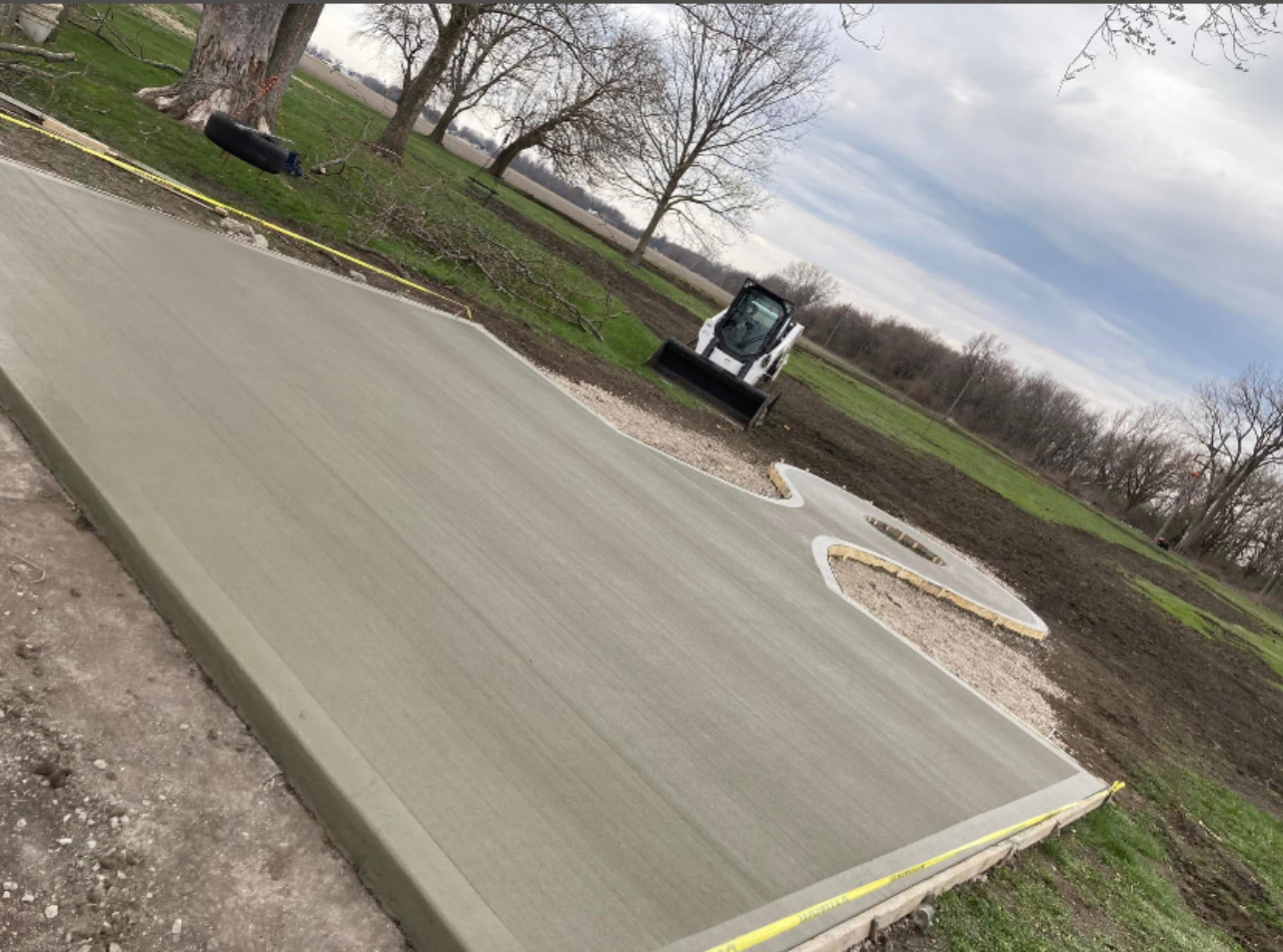 Freshly poured concrete driveway with equipment
